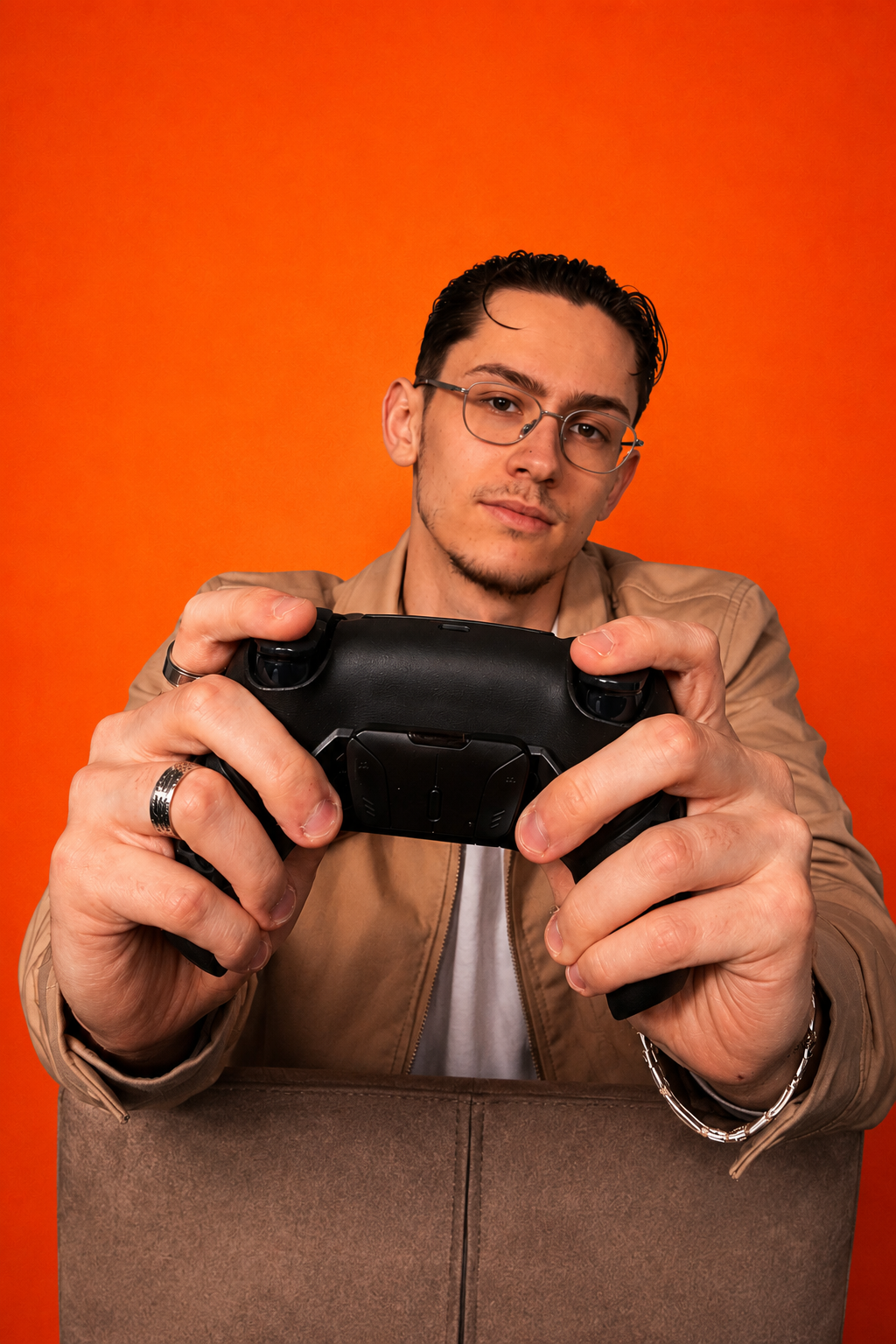 LeTsHe holding a Helico HexaVent gaming controller against an orange background.
