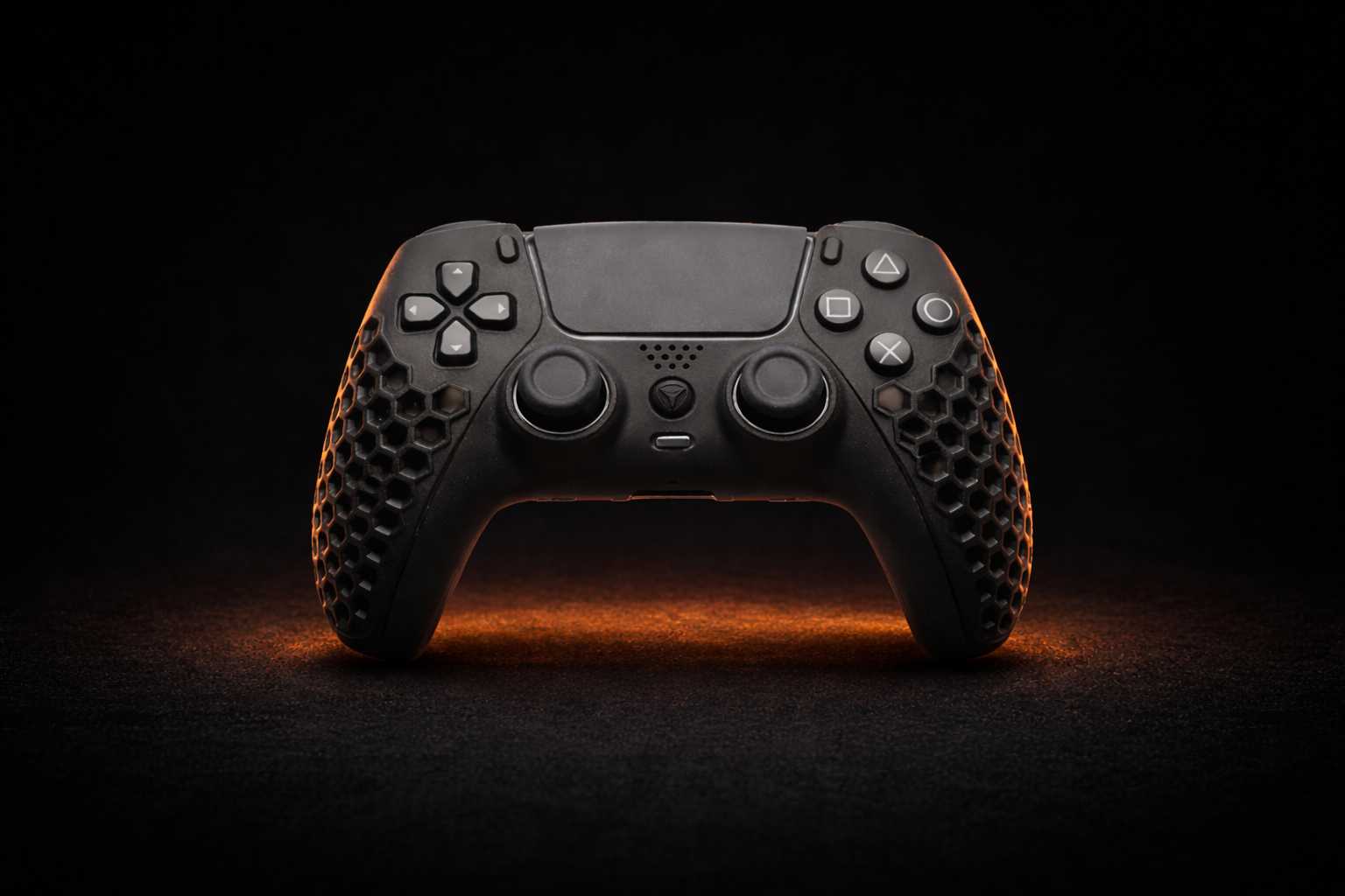 Front view of a premium black Helico HexaVent custom controller for PS5 and PC. The image highlights the distinctive honeycomb ventilated shell design, dramatically lit by a warm orange glow against a dark background.