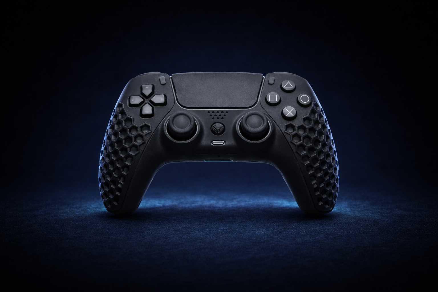 Frontal close-up view of the black Helico HexaVent HX-2 custom PS5 and PC controller. The blue ambient lighting softly highlights the signature honeycomb ventilated grips and the D-pad and action buttons layout