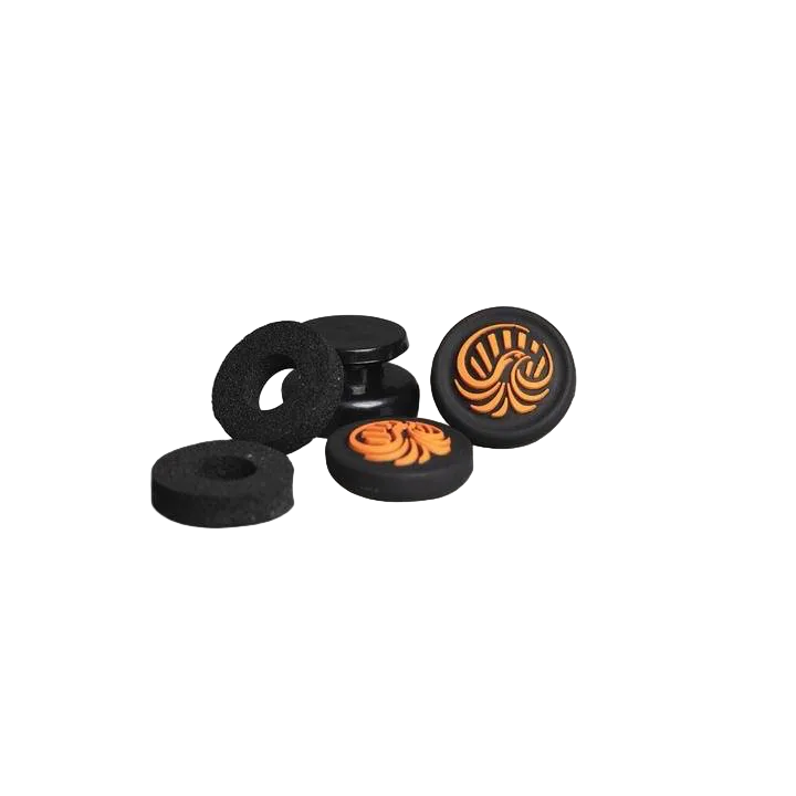 Complete components of the Helico Phoenix Thumbstick Enhancer Kit for custom PS5 and PC controllers. The image displays two black and orange anti-slip thumb grips, a mounting base, and two black foam precision aim rings for movement stabilization, isolated on a transparent background.